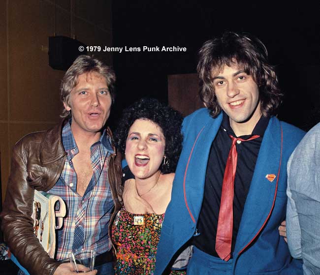 February 26, 1979, Jan Golab, writer for Oui Magazine, Jenny Lens and Sir Bob Geldof, during Boomtown Rats' first LA press conference. I don't wear a bra and Bob just copped a feel. Hence my expression. Look how innocent he looks! Ha, the Rats were GREAT fun on and off stage!